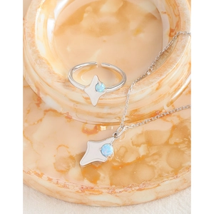 S925 silver star pendant necklace and ring set with blue opal stones on marble base