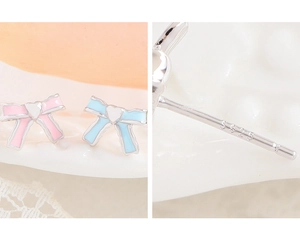 Macro detail of S925 sterling silver stamp on pink enamel bow heart stud earrings
