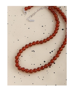 Detailed macro view of S925 silver lobster clasp and red carnelian bead necklace