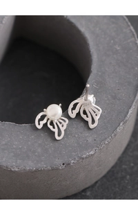 Detailed view of S925 sterling silver wing earrings with pearl and silver hallmark