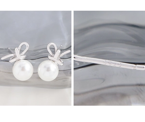 Detail of S925 sterling silver bow earrings with round white pearl and hallmark