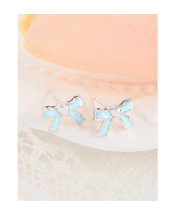 Macro view of S925 sterling silver bow earrings with light blue enamel and heart detail
