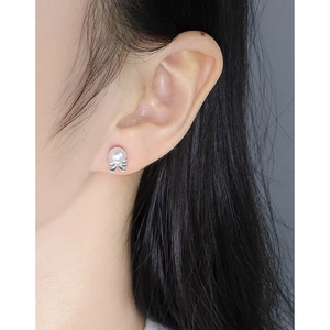 Elegant S925 silver bow pearl earrings shown on model for a graceful feminine look