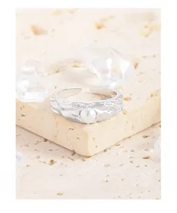 Close-up of S925 silver ring with irregular hammered texture and white round pearl
