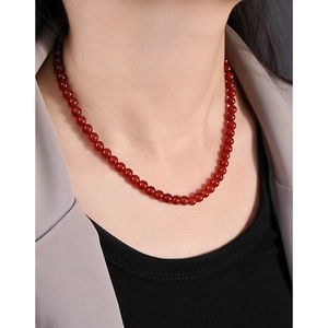 Elegant red agate beaded S925 sterling silver necklace shown on a model neck