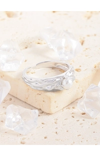 Close-up of S925 sterling silver ring with molten texture and a white pearl accent