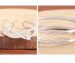 Detail showing S925 hallmark on minimalist double-layered knotted silver ring