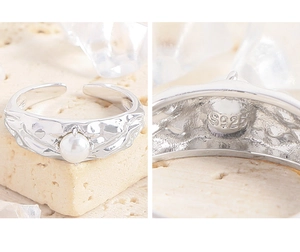 Detailed macro view of S925 sterling silver ring with hammered texture and white pearl