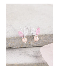 Detail of S925 silver stud earrings with pink zircon rabbit ears and pearl drop