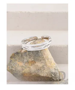 Detailed macro view of S925 sterling silver stamp on intertwined minimalist ring band