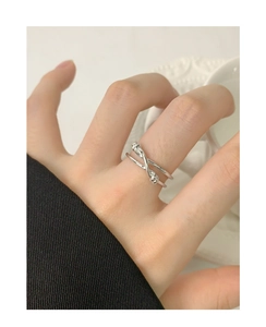 Close-up of S925 sterling silver double-layered knotted ring worn on hand