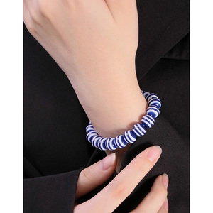 S925 sterling silver beaded bracelet with navy blue and white striped resin beads on wrist