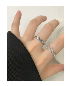 Macro detail of S925 sterling silver knotted ring with colorful gemstones on a model hand