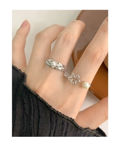 Detail view of S925 silver rings with wrinkled texture and elegant pearl accents