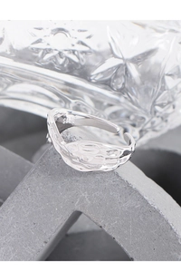 Macro shot of S925 sterling silver open ring featuring a unique hammered lava texture