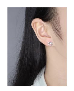 Macro side view of S925 silver moonstone stud earrings featuring a star and bow design