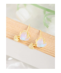 Macro detail of gold S925 silver stud earring with iridescent moonstone and heart charm
