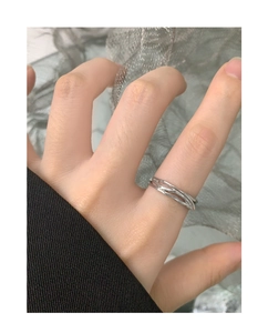 Close-up of S925 sterling silver multi-layer crisscross open ring on a female finger