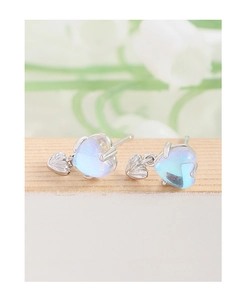 Detailed view of S925 sterling silver heart studs with glowing iridescent moonstone