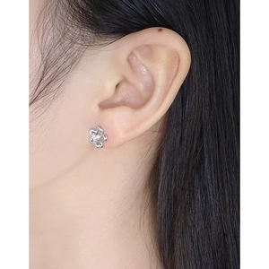 S925 sterling silver flower earrings with white zircon on a model's ear for daily wear
