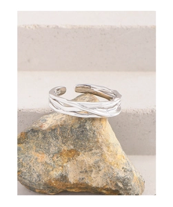 Detailed view of S925 sterling silver ring with liquid texture on a natural stone base