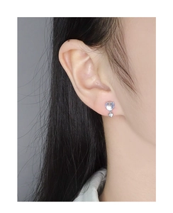 Close-up of S925 silver heart stud earrings with moonstone and a small silver pendant