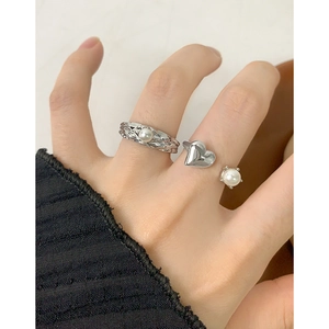 Minimalist S925 silver ring set with textured band and heart pearl design on hand