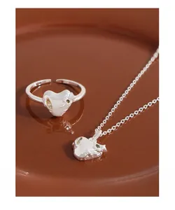 Detailed close-up of S925 silver heart jewelry set with textured irregular surfaces