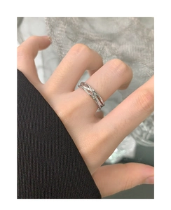 Close-up of S925 sterling silver interlaced ring worn on finger with minimalist style