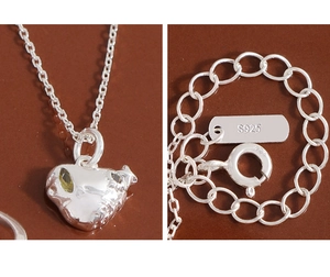 Macro detail of S925 sterling silver heart necklace with a yellow gemstone inlay