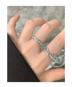 Close-up of S925 sterling silver rings featuring vintage floral relief and wavy lava texture