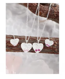 Detail of silver S925 heart necklace and earrings set with pink bow-knot zircon stones
