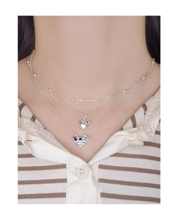Close-up of S925 silver layered necklace featuring multi-colored heart-shaped gemstone pendants