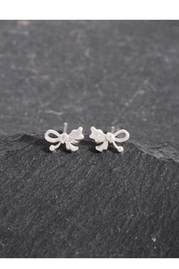 Macro shot of polished S925 sterling silver asymmetrical bow stud earrings for women