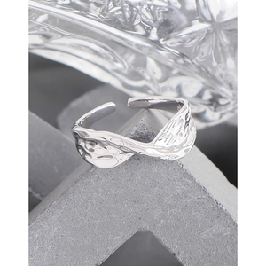 Minimalist S925 sterling silver open ring with irregular lava texture on concrete base