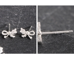 Macro detail of the S925 sterling silver hallmark on an asymmetric bow stud earring
