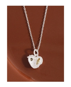 Close-up of S925 sterling silver apple pendant with green and yellow zircon stones