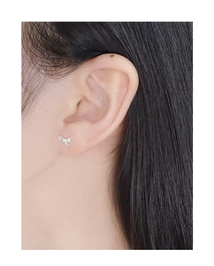Close-up of model wearing an asymmetric S925 sterling silver bow earring for women
