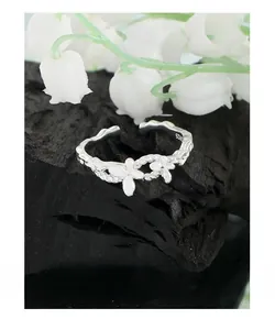 Macro shot of S925 sterling silver ring with double flower design and braided texture