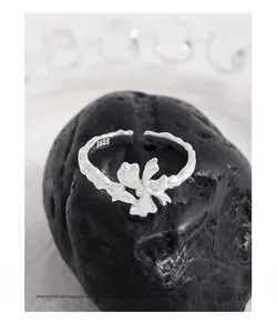 Detailed macro view of S925 sterling silver bow ring featuring organic fluid texture