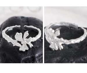 Detail view of S925 sterling silver bow ring featuring irregular texture and hallmarking
