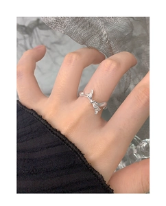 Close-up of S925 sterling silver bow ring with polished mirror finish on finger