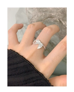Macro detail of S925 sterling silver butterfly ring with realistic texture on model