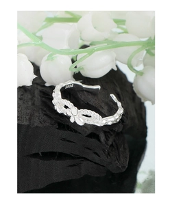 Macro shot of S925 sterling silver butterfly ring with braided rope texture detailing