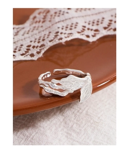 Macro view of S925 silver butterfly ring showing intricate wrinkled texture details