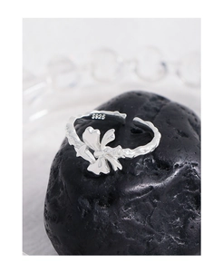Detailed macro shot of S925 sterling silver bow ring with engraved hallmark on black stone