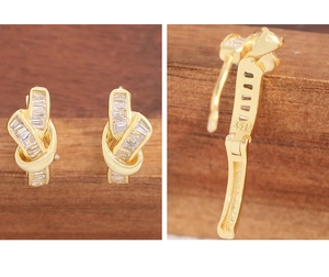 Detailed view of gold-plated knot earrings featuring rectangular cubic zirconia and S925 stamp