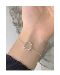 Detailed close-up of a S925 silver bracelet featuring moonstone and butterfly charms