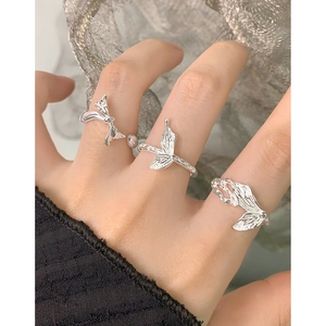 Minimalist S925 sterling silver butterfly rings with textured design worn by a model