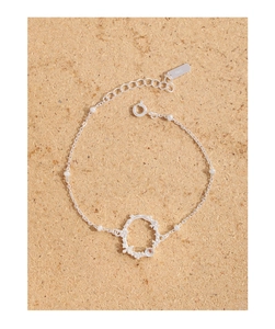 Close-up of S925 sterling silver bracelet showing floral butterfly charms and moonstone